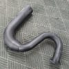 A C2 / C3 Side Exit Exhaust Smoothy Style Transition Pipes laying on a carpet.