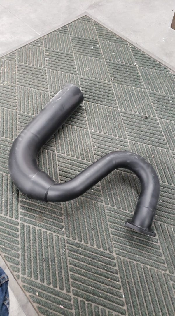 A C2 / C3 Side Exit Exhaust Smoothy Style Transition Pipes laying on a carpet.