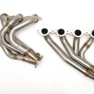 A pair of C2 / C3 Corvette LS Conversion Mid-Length Headers on a white background.