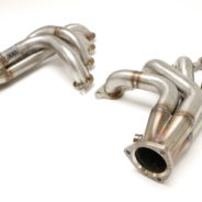 A pair of C2 / C3 Corvette LS Conversion Mid-Length Headers on a white background.