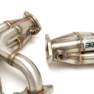 A pair of C2 / C3 Corvette LS Conversion Mid-Length Headers on a white background.