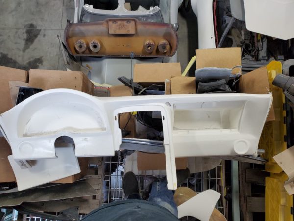 A C3 CORVETTE CUSTOM DASH (Speedvette styled) is sitting in a pile of boxes.