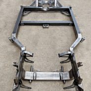 A COFFMAN C2 PERFORMANCE CHASSIS frame for a car on a concrete floor.