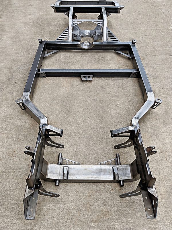 A COFFMAN C2 PERFORMANCE CHASSIS frame for a car on a concrete floor.