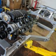 A COFFMAN C2 PERFORMANCE CHASSIS is sitting on a table in a garage.