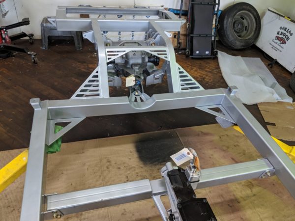 A COFFMAN C2 PERFORMANCE CHASSIS is being built in a garage.
