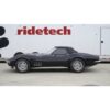 A black 1963-1982 C2-C3 Corvette StreetGrip Suspension System parked in front of a ridetech truck.