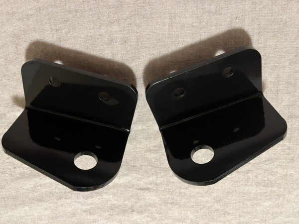 Two C3 Electric Headlight Conversion Kit brackets on a white surface.