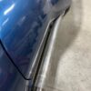 A close up of a blue car with C2/C3 CORVETTE LS SWAP STAINLESS STEEL SIDE EXIT HEADERS - MILL FINISH.