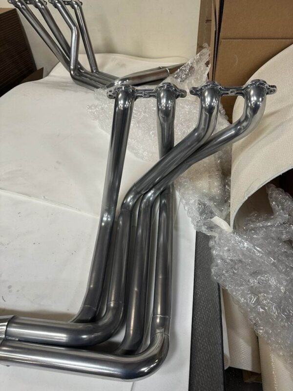 A group of C2/C3 CORVETTE LS SWAP STAINLESS STEEL SIDE EXIT HEADERS - POLISHED FINISH.