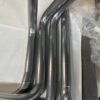 A set of C2/C3 CORVETTE LS SWAP STAINLESS STEEL SIDE EXIT HEADERS - POLISHED FINISH on a table.