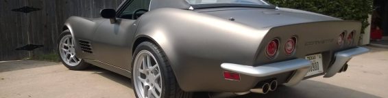 gray corvette parked in driveway